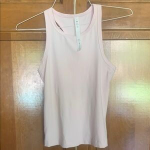 Lululemon racer back pink tank size 6 . Slightly worn , no snags.